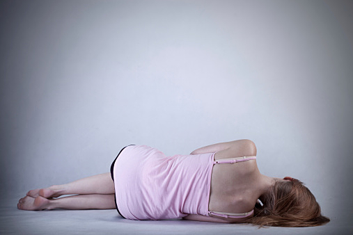 Skinny girl lying on the floor